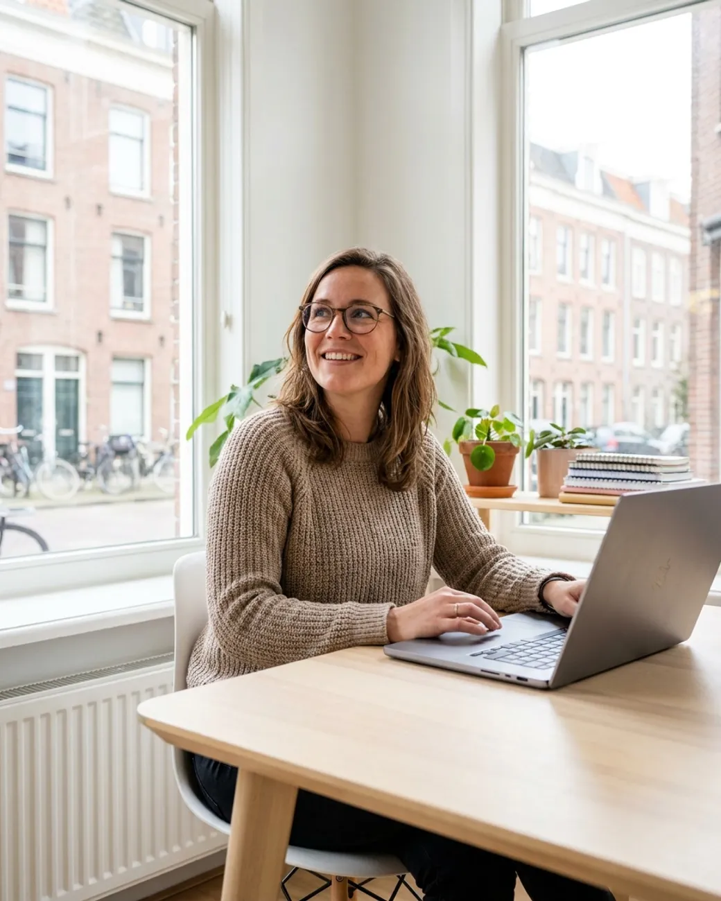 A happy entrepreneur smiling while working at her laptop